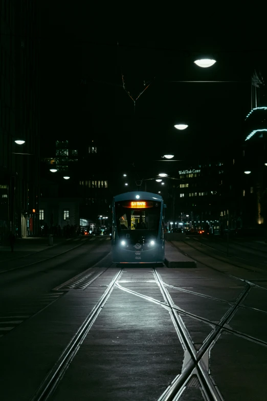 a trolley at night near the light rail line