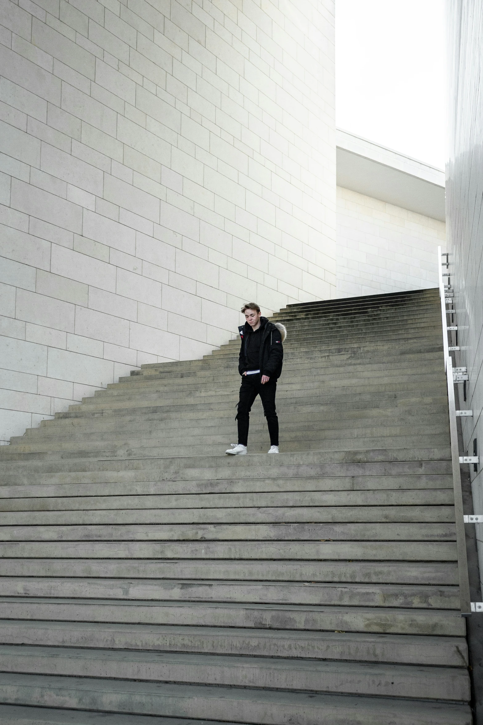 man standing on steps at entrance of building