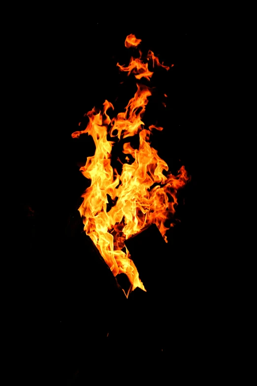 a dark fire with lots of bright yellow flames