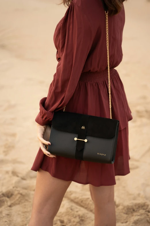 a woman wearing red carrying a black purse