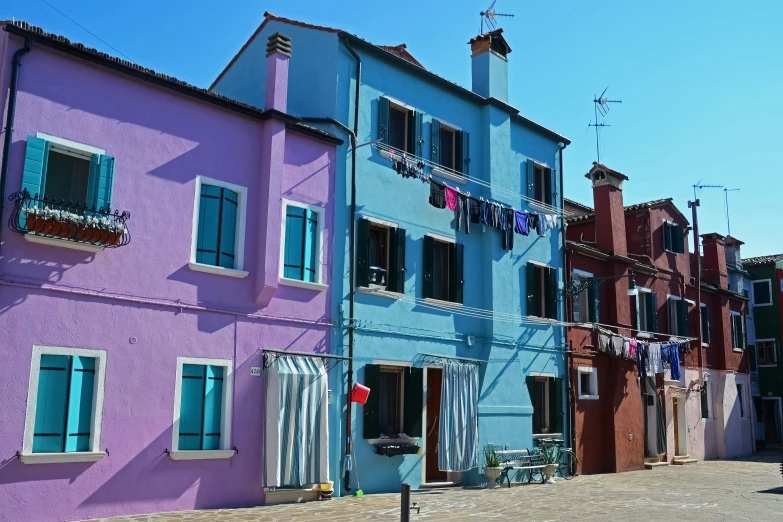 a group of buildings painted bright pink and blue