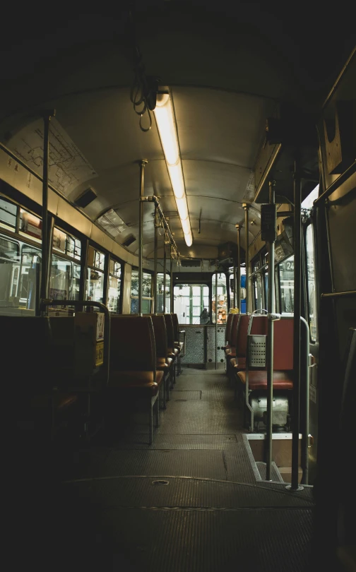 an empty bus with lots of seats inside