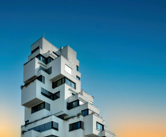 a tall white building against a blue sky