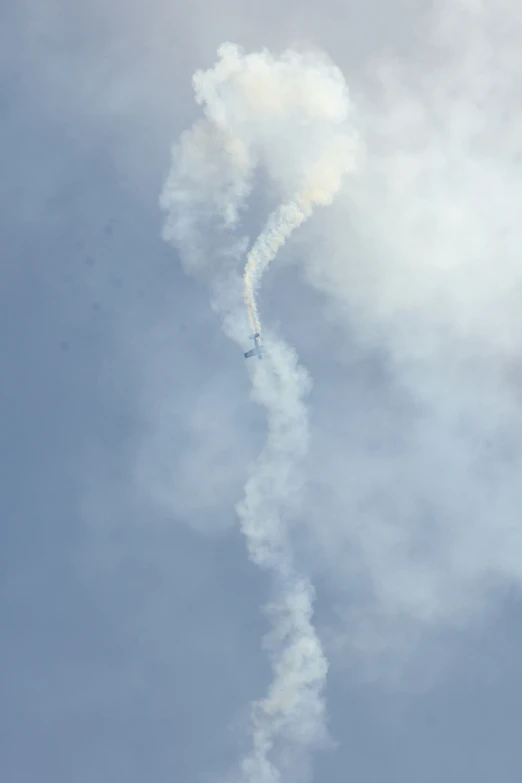smoke pouring out from an airplane tail with two planes passing behind
