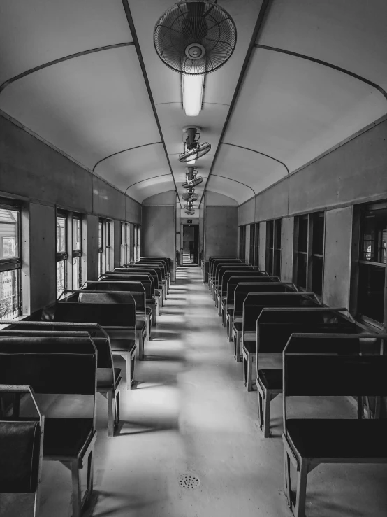 a black and white image of a train car with windows