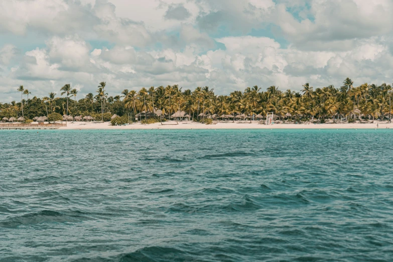 an island is near a white sand beach