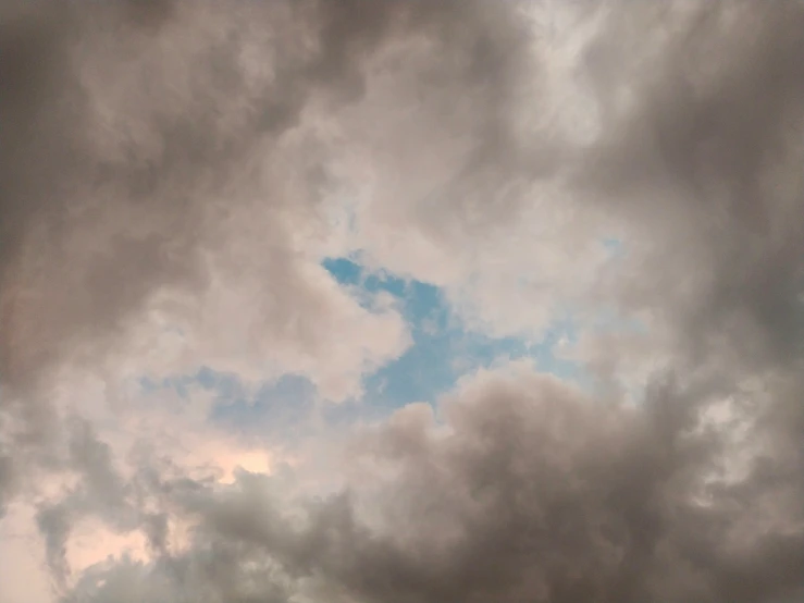 a plane flying through a very cloudy sky