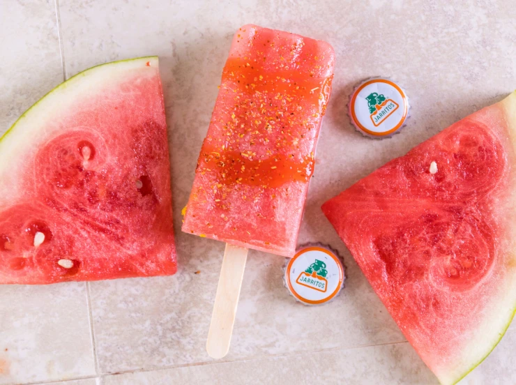 three popsicles, one is watermelon and one is gfruit