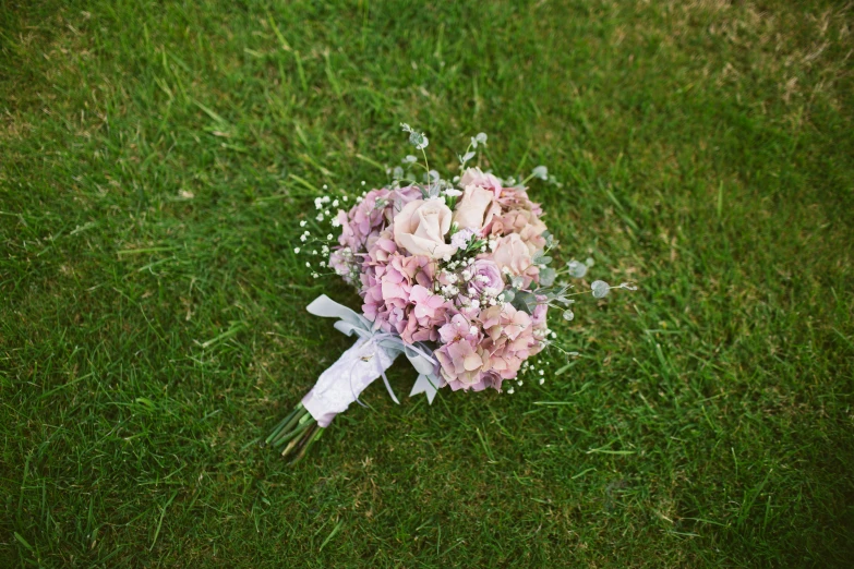 a bouquet of flowers in the grass on the lawn