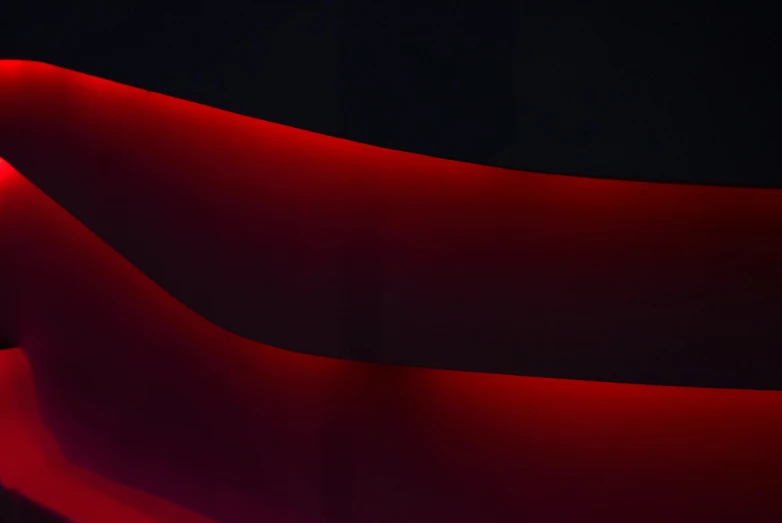 red fabric with black background and a white wall