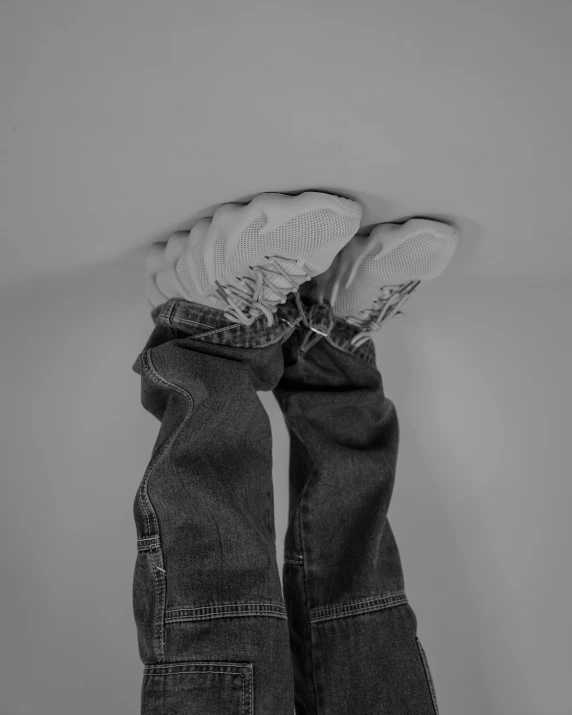 two pairs of jeans tied together to the ceiling