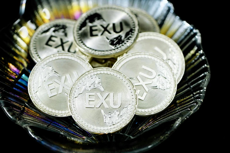 some silver coin sitting on top of a table