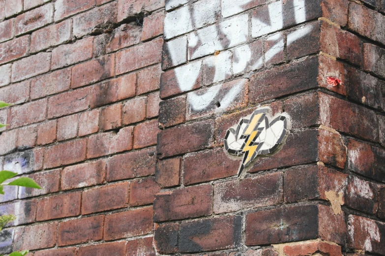 a brick wall with graffiti and some writing on it