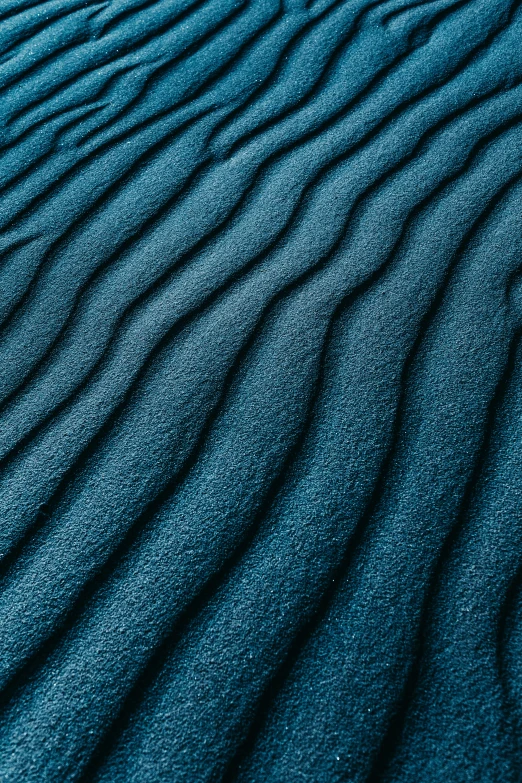 some very small waves on top of blue material