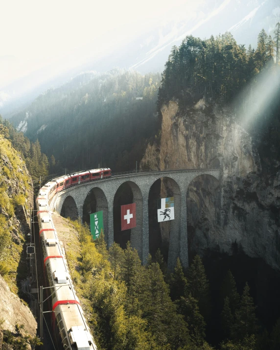 a train that is on the tracks next to some trees