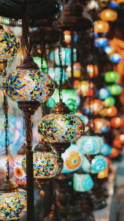 many colorful glass balls hang from a hanging lamp