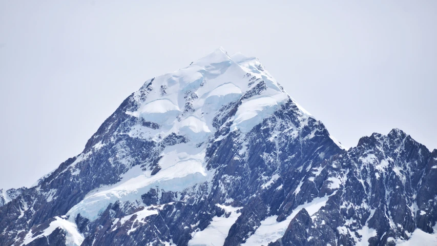 the side of a mountain with some snow on top