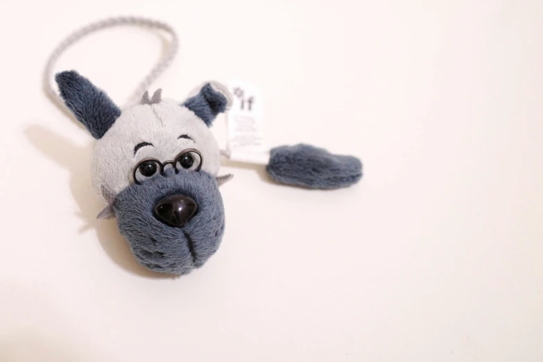 a stuffed toy dog with a tag attached to it