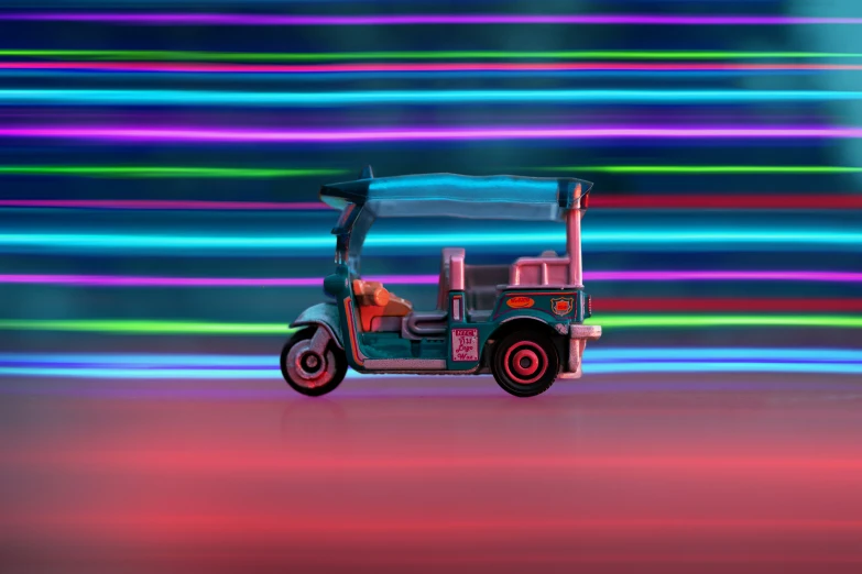 a car is in front of a colorful background