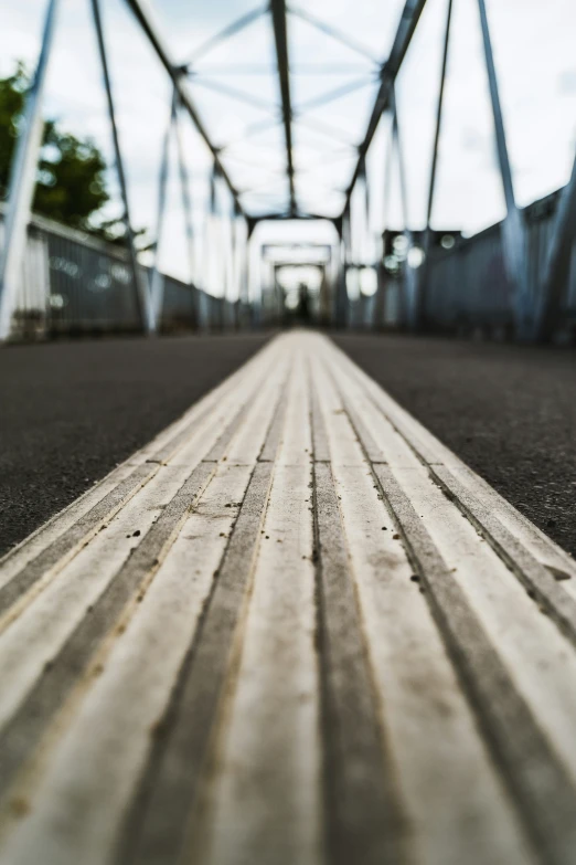 a view looking down an empty street that has lines painted on the ground