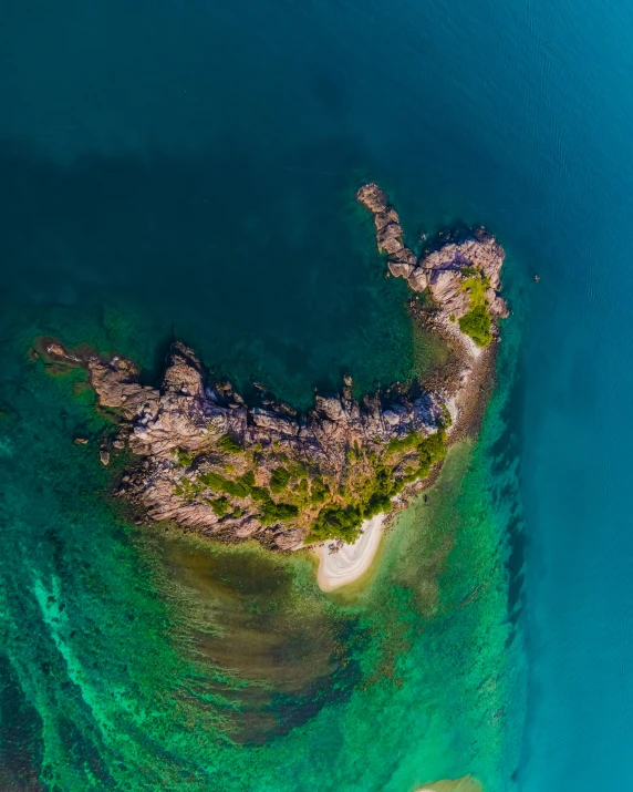 an aerial view of a sandy island in the ocean