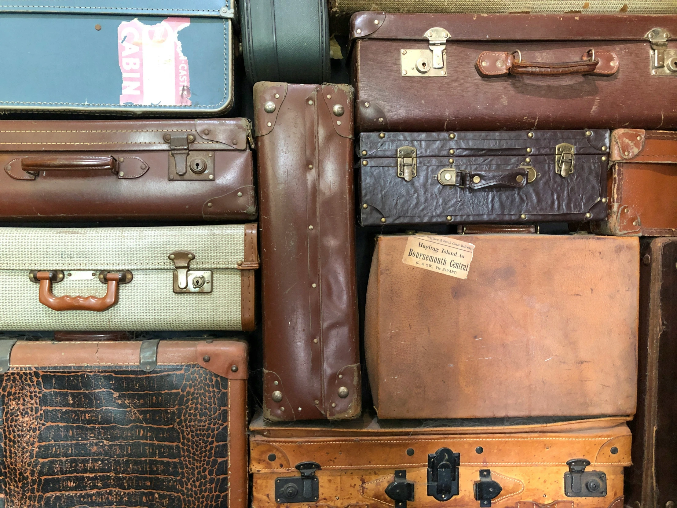 a stack of suit cases sitting next to each other