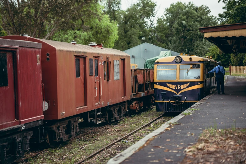 an old train on the tracks at a station