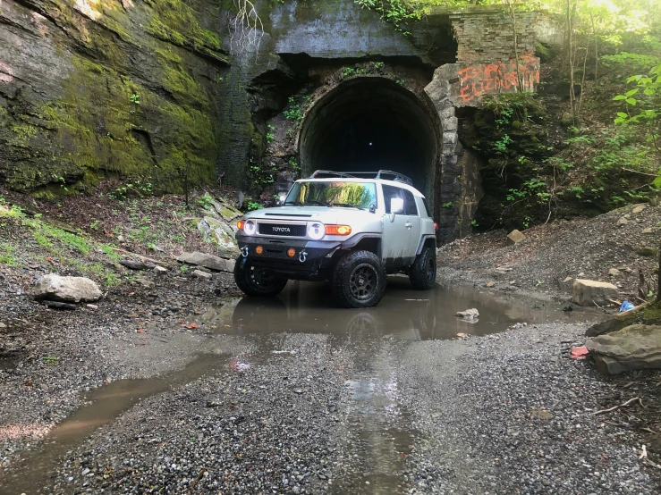 an suv in the middle of a muddy road