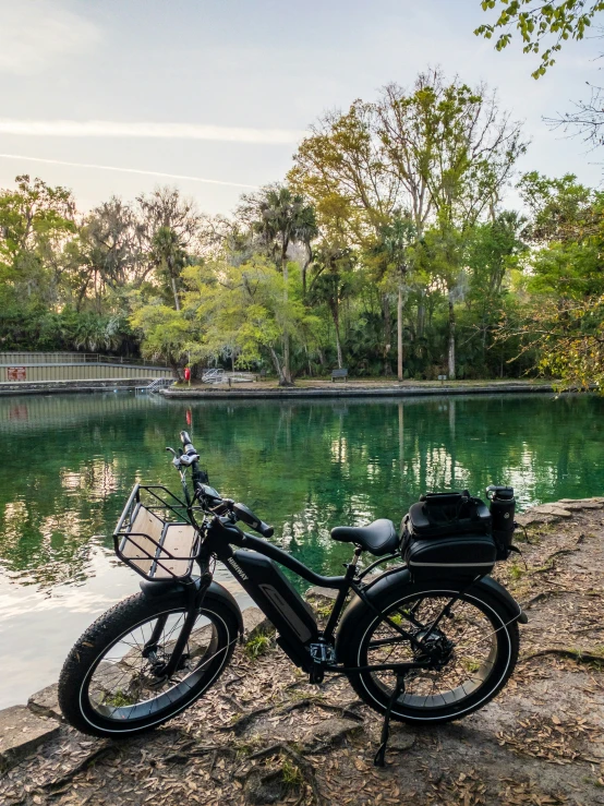 an old fashioned motorcycle parked next to the water