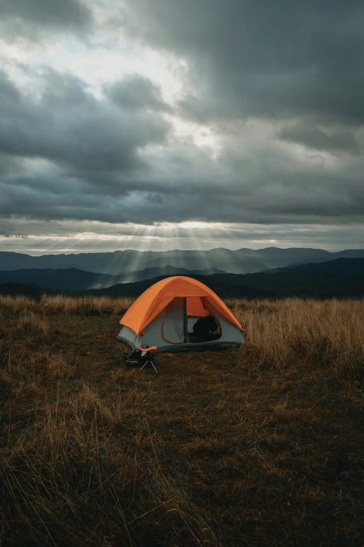 someone is sitting in their tent out in the distance