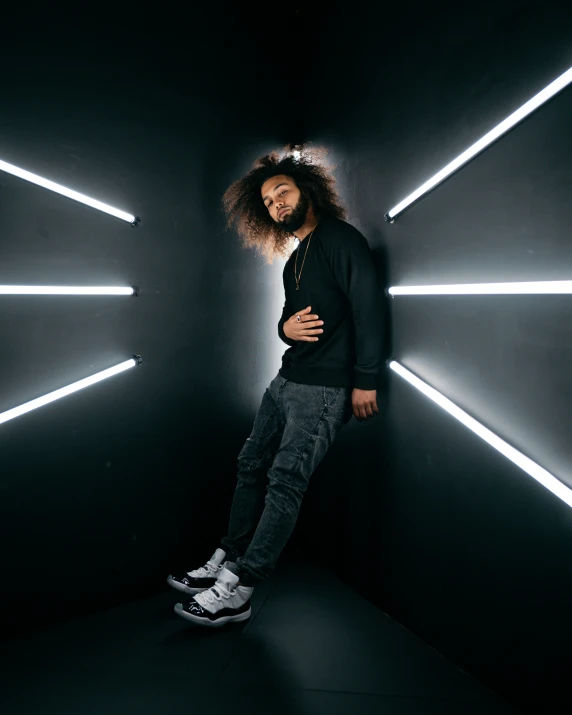 a man is standing in a dark tunnel and posing for the camera