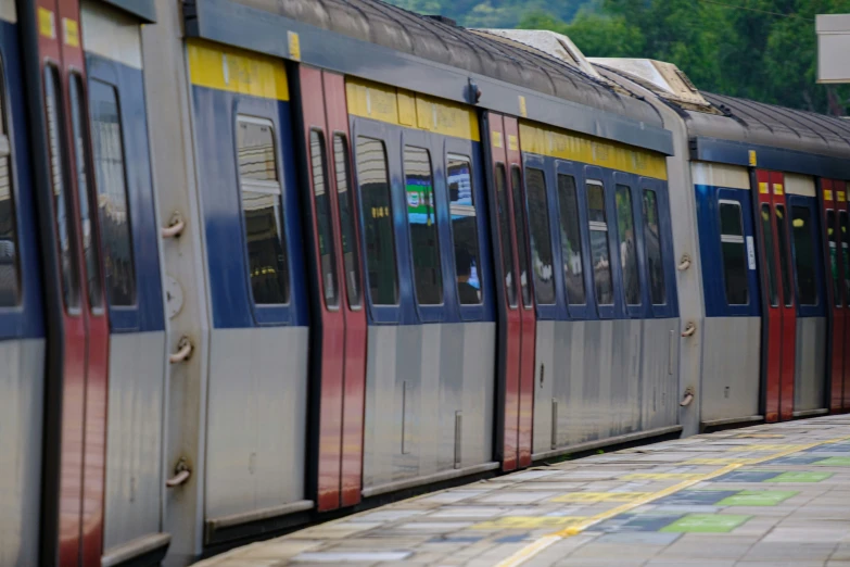 a grey red blue yellow and gray passenger train