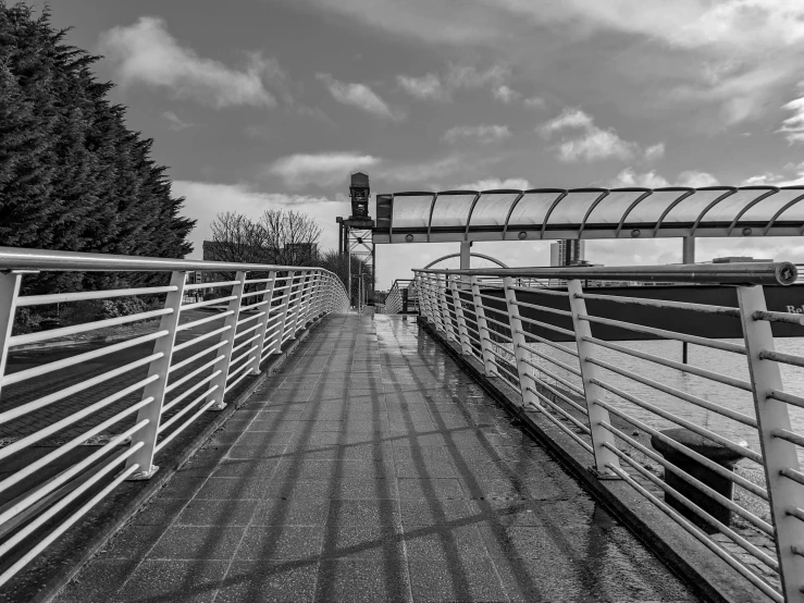 a bridge spanning over the water on a cloudy day