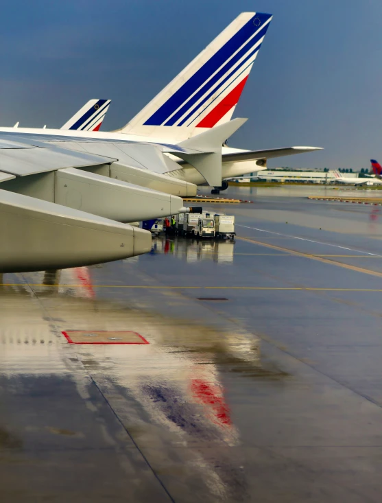 a few planes are parked on the runway