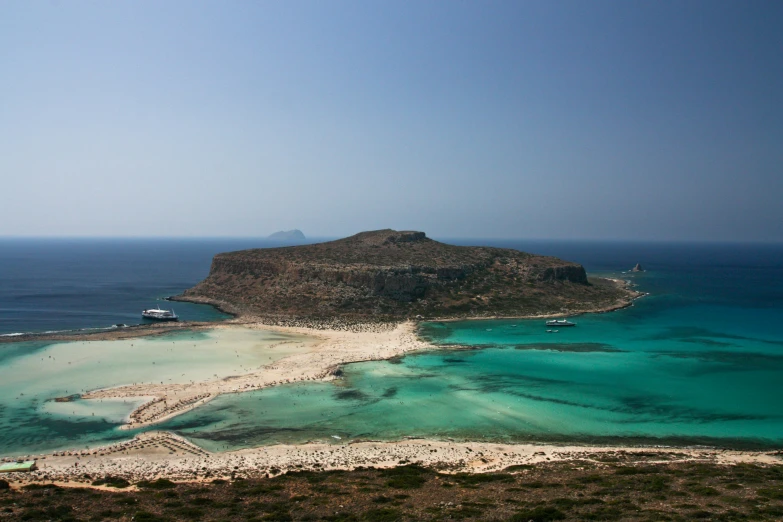 a small island sits in the middle of a large body of water