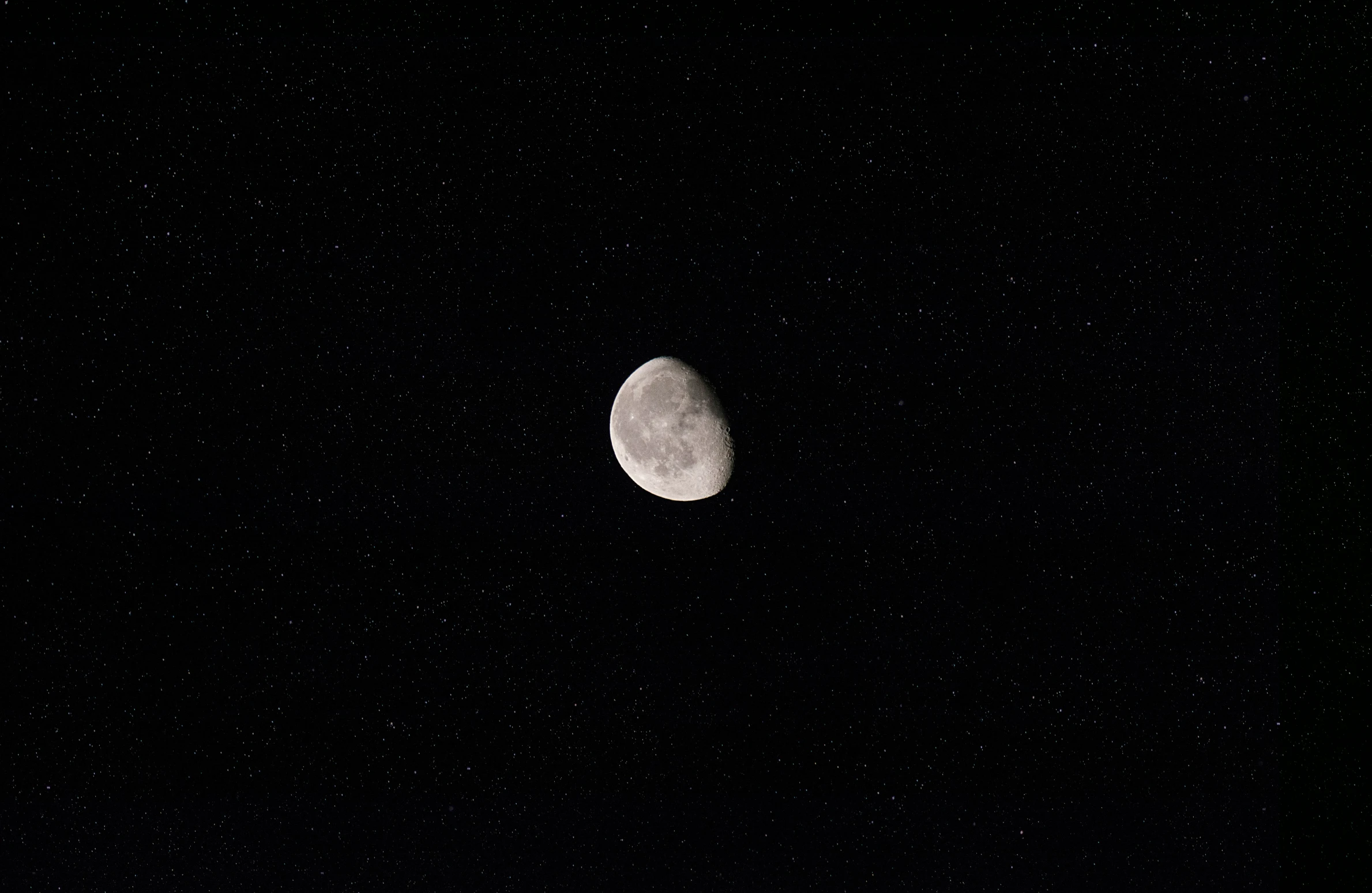 a half moon is shown in the dark sky