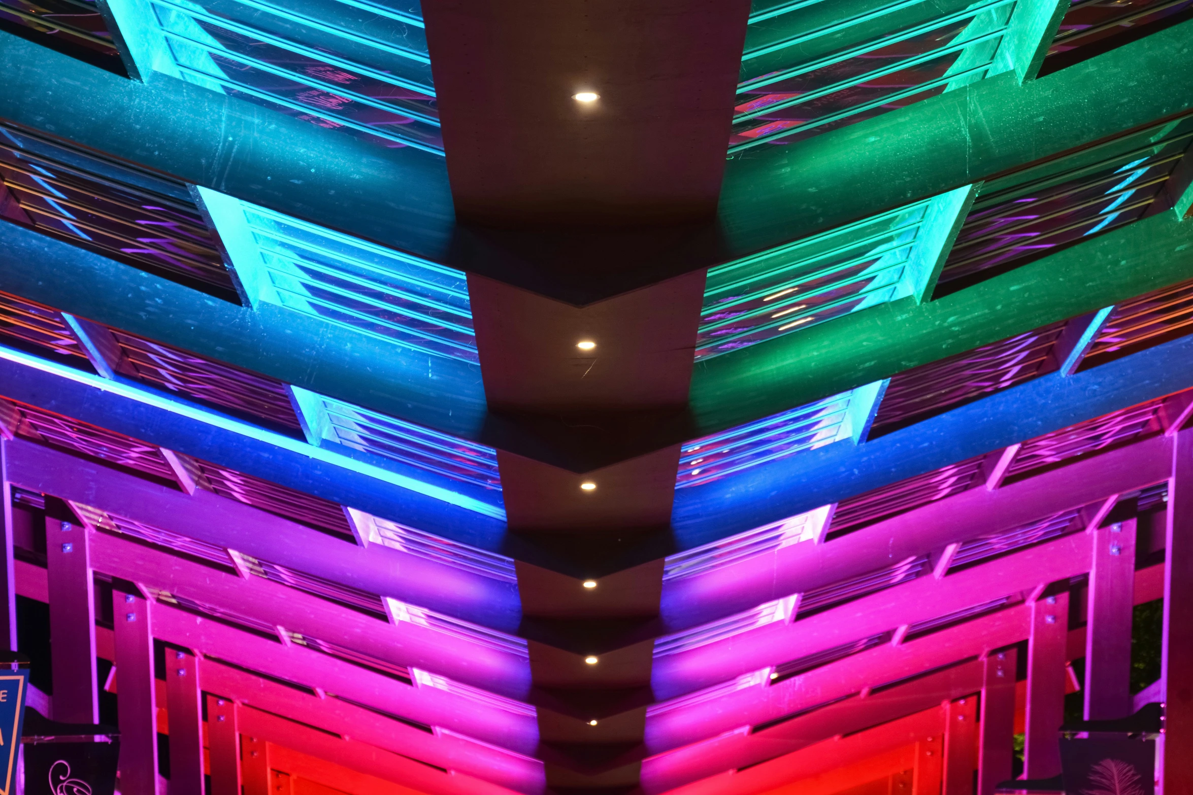 a walkway inside of a large building with many colors