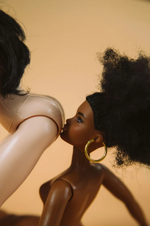 two dolls, one with an afro, the other in gold earrings