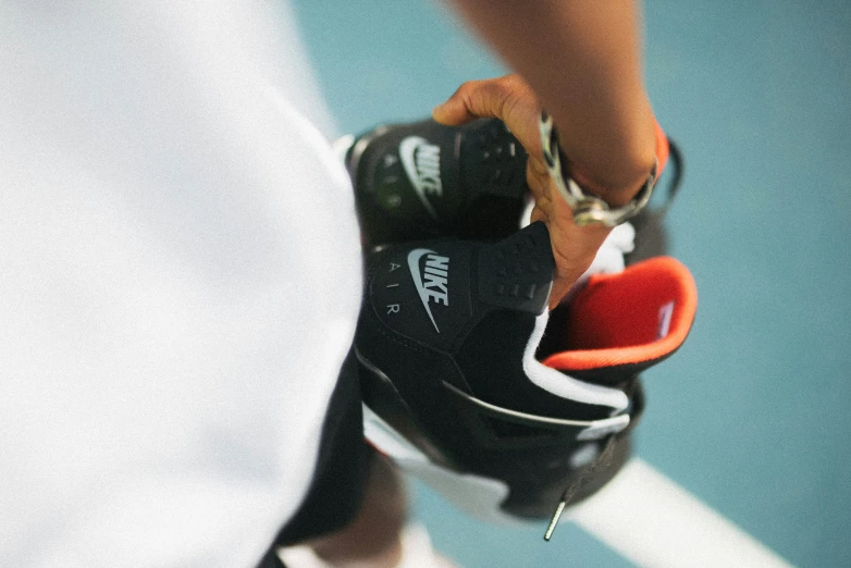 a close - up s of a professional tennis player tying his sneakers