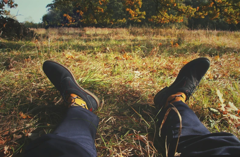 two people with brown shoes and black pants