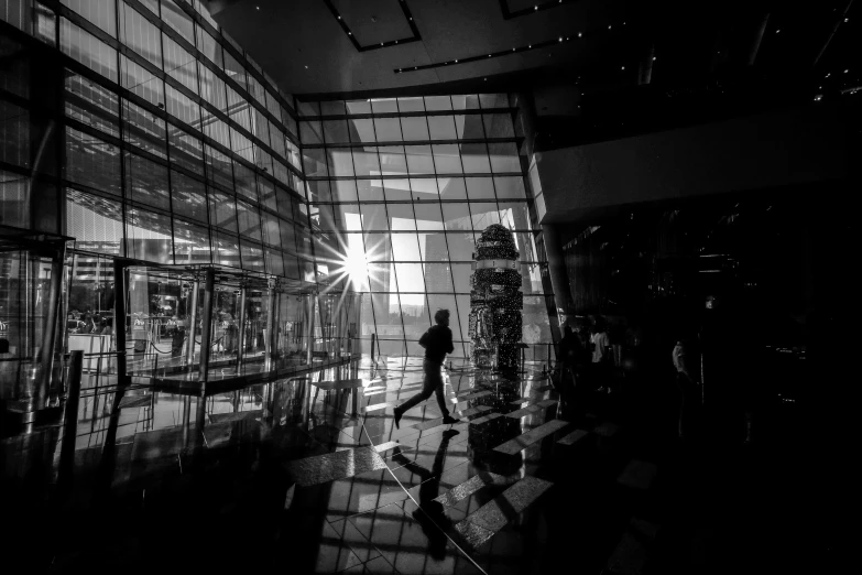 a black and white image with reflections of people in a mirror