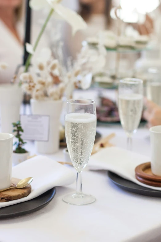 two drinks are placed on a table near some snacks