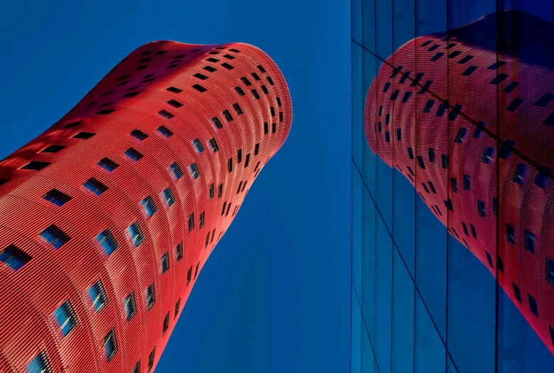 two tall buildings that are red with lines