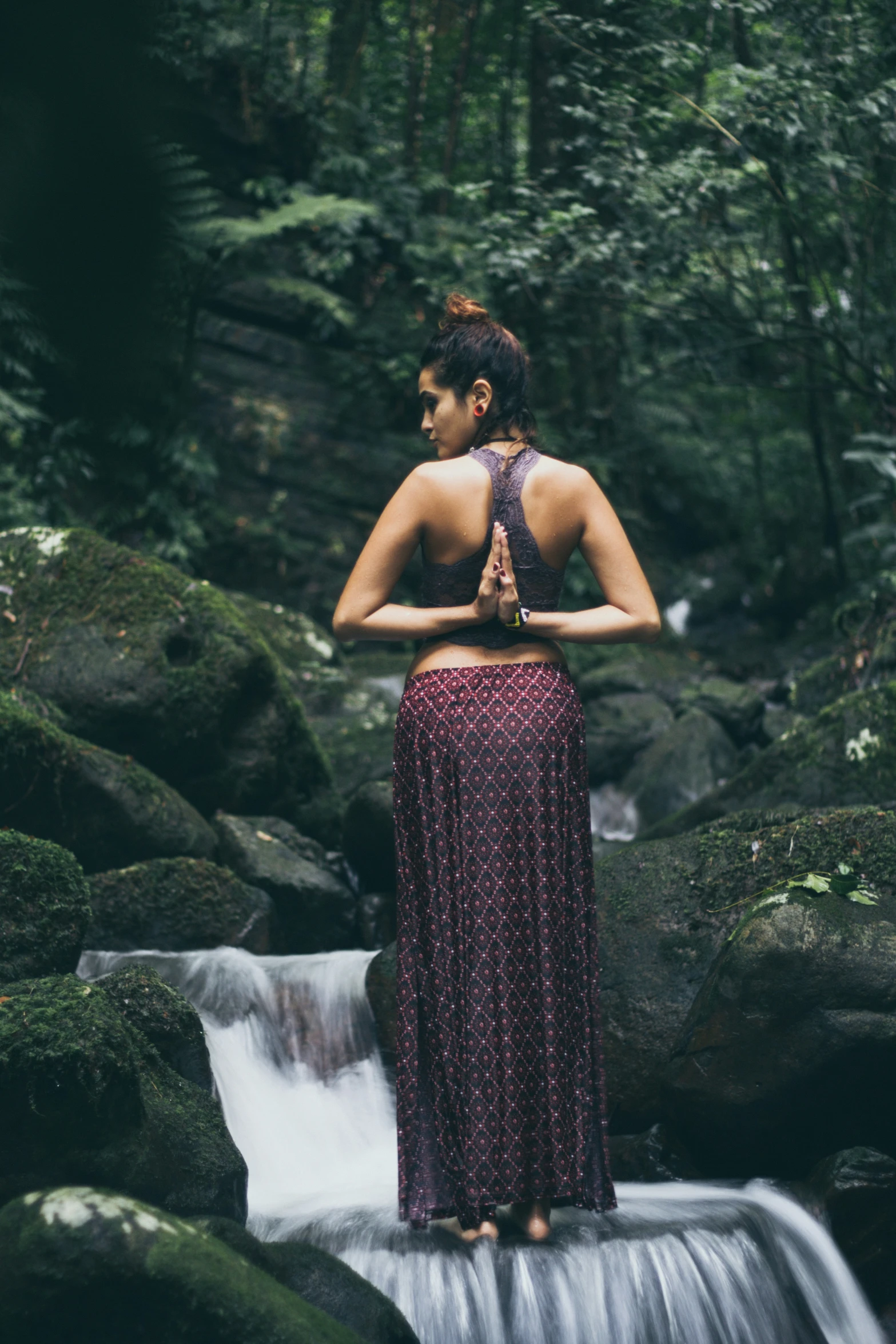 a woman that is standing up in the grass