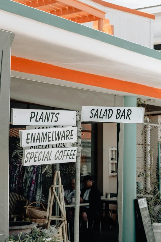 the sign has two signs saying plant names