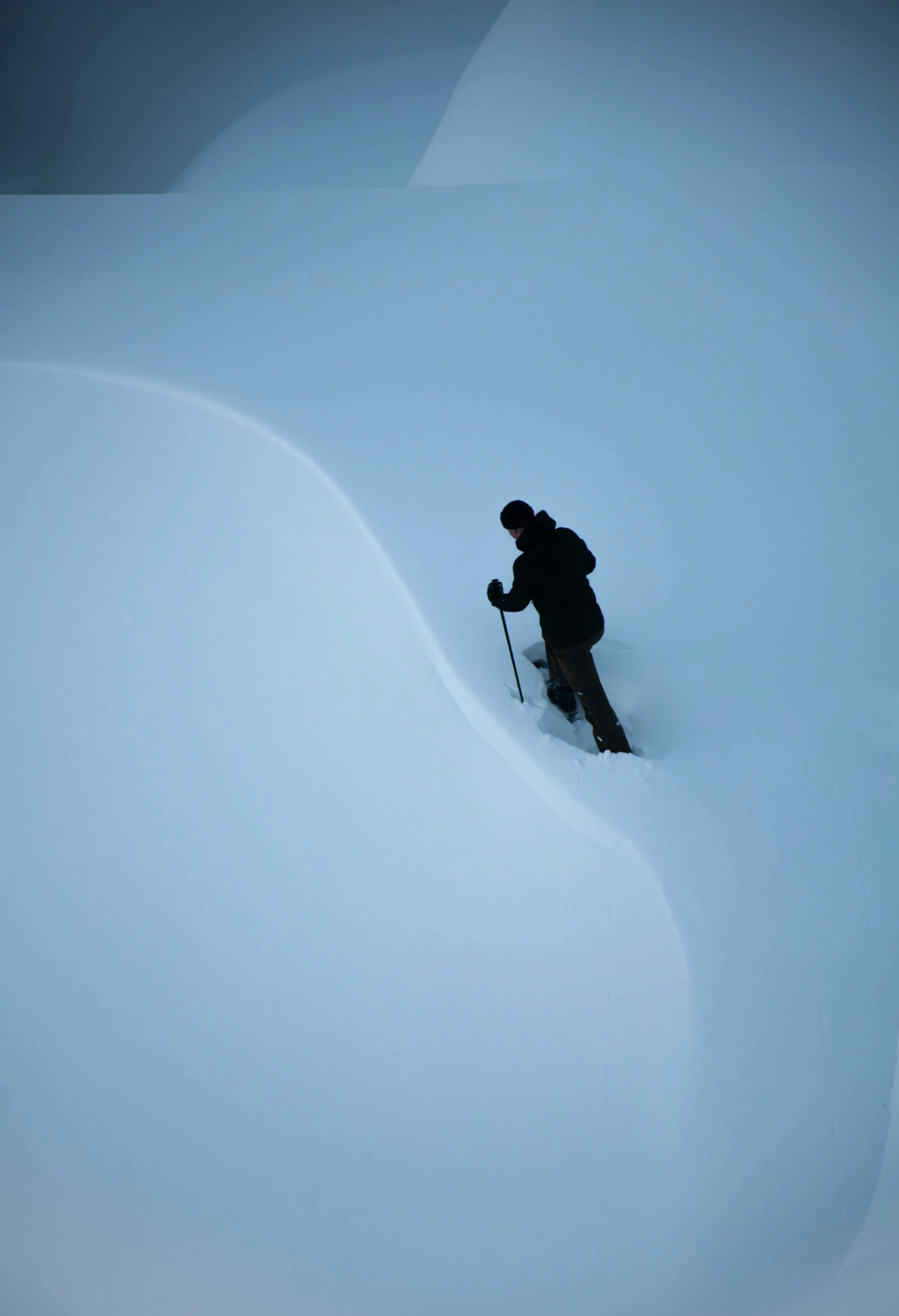 a man cross country skiing through the snow