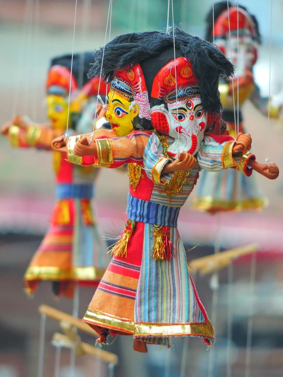 a wooden doll with four strings