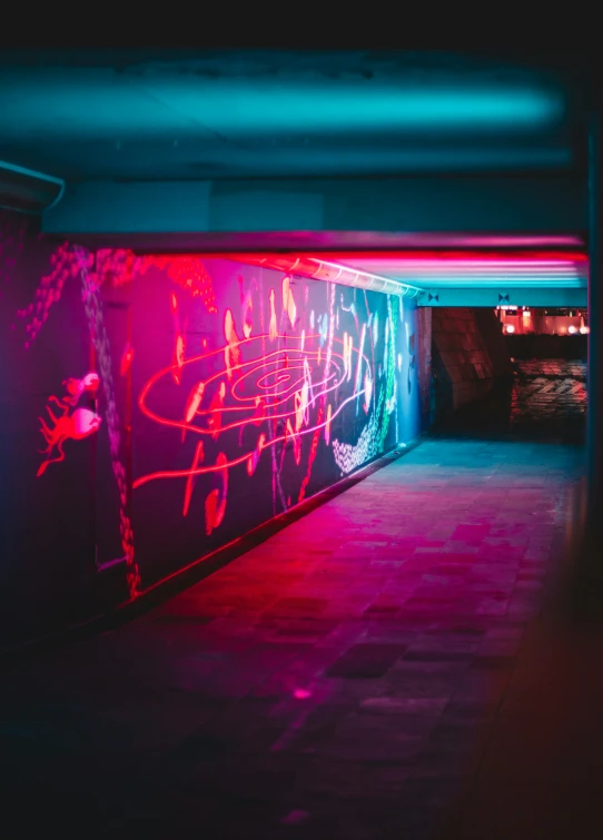 a building with a graffiti filled wall and purple lights