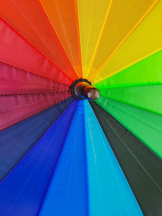 a multi colored umbrella looking up with colors