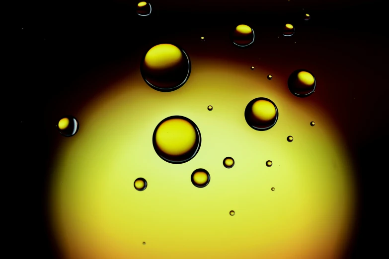 drops of oil on a black surface